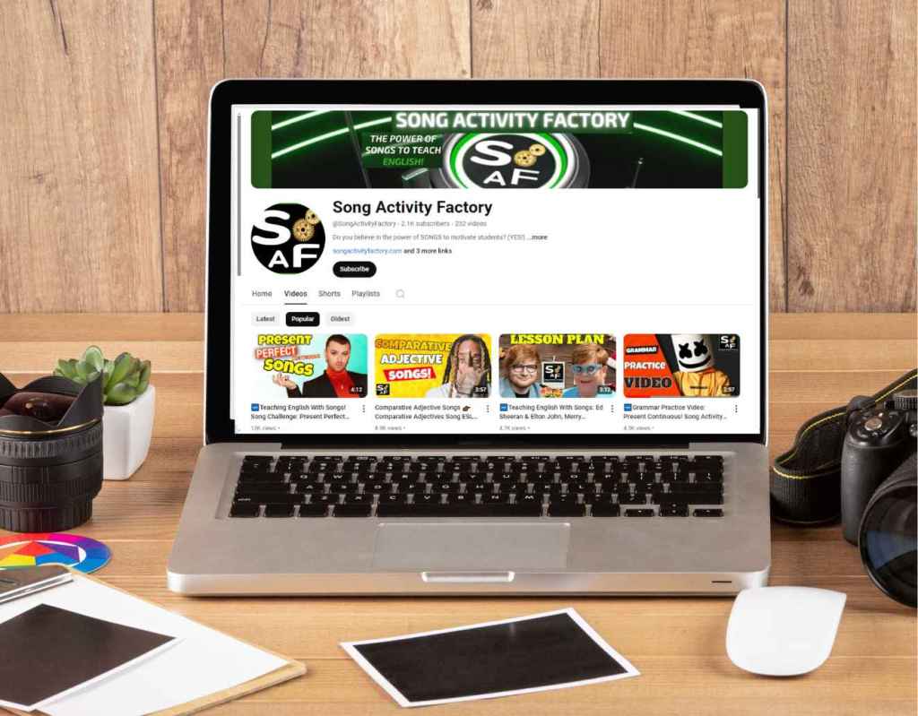 Laptop displaying Song Activity Factory YouTube channel homepage